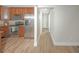 Hallway with gray walls that connects to the kitchen with matching wood floors at 8610 Fish Lake Rd, Tampa, FL 33619