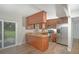 Modern kitchen with stainless steel appliances, granite countertops, and a breakfast bar area at 8610 Fish Lake Rd, Tampa, FL 33619