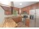 Well-equipped kitchen with stainless steel appliances, granite countertops, and wood cabinets at 8610 Fish Lake Rd, Tampa, FL 33619
