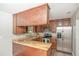 Well-equipped kitchen features stainless steel appliances, wooden cabinets, and granite countertops at 8610 Fish Lake Rd, Tampa, FL 33619