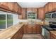 This kitchen features stainless steel appliances and wooden cabinets overlooking the outdoors at 8610 Fish Lake Rd, Tampa, FL 33619