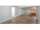 Open-concept living room boasts wood floors, natural light, and convenient access to the backyard at 8610 Fish Lake Rd, Tampa, FL 33619