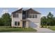 Two-story home featuring a two-car garage, neutral stucco, dark brown accents, and a covered front entryway at 9360 Gladsome Dr, Land O Lakes, FL 34637