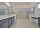 Modern bathroom with double vanity, quartz countertop, large shower with glass doors, and stylish lighting at 955 Signet Dr, Apollo Beach, FL 33572
