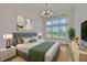 Bedroom featuring a plush bed, large window with natural light, and stylish decor for a cozy retreat at 955 Signet Dr, Apollo Beach, FL 33572
