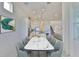 Bright dining room featuring open concept with a modern table, large windows, and a kitchen view at 955 Signet Dr, Apollo Beach, FL 33572