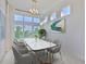 Bright dining room with a modern chandelier, large windows, and marble table at 955 Signet Dr, Apollo Beach, FL 33572