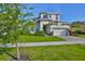 Two-story home featuring manicured lawn, beautiful landscaping, and a two car garage at 955 Signet Dr, Apollo Beach, FL 33572
