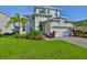 Charming two-story home with manicured lawn, beautiful landscaping, and a paver driveway at 955 Signet Dr, Apollo Beach, FL 33572