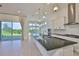 Modern kitchen with a large island, stainless steel appliances, and open view to the outdoors at 955 Signet Dr, Apollo Beach, FL 33572