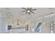 An open-concept kitchen with stainless steel appliances, white cabinets, an island with a sink, and pendant lighting at 955 Signet Dr, Apollo Beach, FL 33572