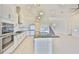 Modern kitchen boasts white cabinets, stainless steel appliances, granite countertops, and a stylish island with sink at 955 Signet Dr, Apollo Beach, FL 33572