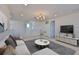 Living room with a large tv and view of the staircase at 955 Signet Dr, Apollo Beach, FL 33572