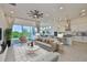 Open-concept living room featuring modern decor, a ceiling fan, and sliding glass doors at 955 Signet Dr, Apollo Beach, FL 33572