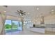 Open-concept living room with modern fixtures and a view of the kitchen and dining room at 955 Signet Dr, Apollo Beach, FL 33572