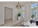 Office space with bright lighting, a modern desk, decorative chandelier, and neutral color palette at 955 Signet Dr, Apollo Beach, FL 33572