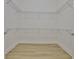 Spacious walk-in closet with wood-look floor and metal shelving at 955 Signet Dr, Apollo Beach, FL 33572