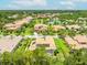 Community aerial view with tile roofs, lush landscaping, community lakes, and beautiful homes at 1014 Stella Vara Dr, Lutz, FL 33548