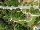 Serene aerial view of community park featuring walking trails, gazebo, and lush landscaping for neighborhood enjoyment at 1014 Stella Vara Dr, Lutz, FL 33548