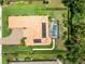 Aerial view of home featuring a tile roof, solar panels, a screened-in pool, and mature landscaping at 1014 Stella Vara Dr, Lutz, FL 33548