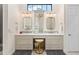 Bright bathroom with dual sinks, white cabinets, and gray accents offer a modern design at 1014 Stella Vara Dr, Lutz, FL 33548