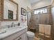 Bathroom featuring glass shower doors, a marble countertop, and elegant fixtures at 1014 Stella Vara Dr, Lutz, FL 33548