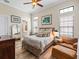 Comfortable bedroom with wood floors, multiple windows, and stylish decor at 1014 Stella Vara Dr, Lutz, FL 33548