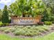 Entrance sign to the Paseo Del Lago community, surrounded by lush landscaping at 1014 Stella Vara Dr, Lutz, FL 33548