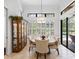 A dining area with views of the pool, a decorative hutch, and stylish furnishings at 1014 Stella Vara Dr, Lutz, FL 33548
