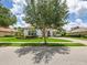 Front exterior of white single-story home, showing manicured landscaping, driveway, and clay tile roof at 1014 Stella Vara Dr, Lutz, FL 33548