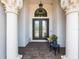 Elegant front entrance featuring decorative columns, a beautiful glass door, and a cozy bench at 1014 Stella Vara Dr, Lutz, FL 33548