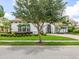 Beautifully landscaped front yard leading to a stunning house with a terracotta tile roof at 1014 Stella Vara Dr, Lutz, FL 33548