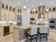 A gourmet kitchen featuring an island with seating, custom cabinets, and modern stainless steel appliances at 1014 Stella Vara Dr, Lutz, FL 33548