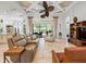 Comfortable living room with multiple seating areas, a ceiling fan, and a view of the pool at 1014 Stella Vara Dr, Lutz, FL 33548