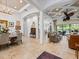 Open-concept living space featuring travertine floors, an open floor plan, and direct lanai access at 1014 Stella Vara Dr, Lutz, FL 33548