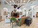 Open-concept living room with coffered ceiling, decorative vases, and stone accents, plus lots of seating at 1014 Stella Vara Dr, Lutz, FL 33548