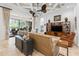 Inviting living room with a large sliding glass door, a stylish ceiling fan, and lots of natural light at 1014 Stella Vara Dr, Lutz, FL 33548