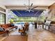 Outdoor living area includes a fireplace, television, seating, dining, and a built-in outdoor kitchen at 1014 Stella Vara Dr, Lutz, FL 33548