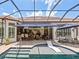 The beautiful backyard with a pool area and the seating around, all enclosed with a screen at 1014 Stella Vara Dr, Lutz, FL 33548