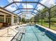 Beautiful screened pool with blue tile and patio furniture offers the perfect outdoor retreat at 1014 Stella Vara Dr, Lutz, FL 33548