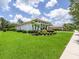Expansive green side yard with manicured landscaping surrounding this elegant home at 1014 Stella Vara Dr, Lutz, FL 33548