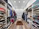 Spacious walk-in closet with custom shelving, center seating and ample space for storage at 1014 Stella Vara Dr, Lutz, FL 33548