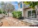 Private backyard featuring stone pavers, lush landscaping, and sliding glass door access at 103 E Davis Blvd # B, Tampa, FL 33606