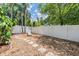 Secluded backyard oasis with decorative stone pavers, lush trees, and privacy fence at 103 E Davis Blvd # B, Tampa, FL 33606