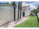 Townhouse with a well-manicured backyard featuring an artificial lawn and palm trees at 103 E Davis Blvd # B, Tampa, FL 33606