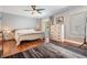 Bright bedroom with hardwood floors, ceiling fan, and sliding glass doors to a private balcony at 103 E Davis Blvd # B, Tampa, FL 33606