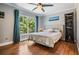The main bedroom features a ceiling fan and a large window overlooking tropical greenery at 103 E Davis Blvd # B, Tampa, FL 33606