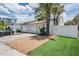 Home exterior features a driveway, a white garage door, and small artificial lawn at 103 E Davis Blvd # B, Tampa, FL 33606
