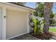 Townhouse featuring the unit number and a beautifully landscaped yard with a palm tree at 103 E Davis Blvd # B, Tampa, FL 33606