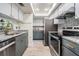 Modern kitchen features stainless steel appliances, gray cabinetry, and granite countertops at 103 E Davis Blvd # B, Tampa, FL 33606